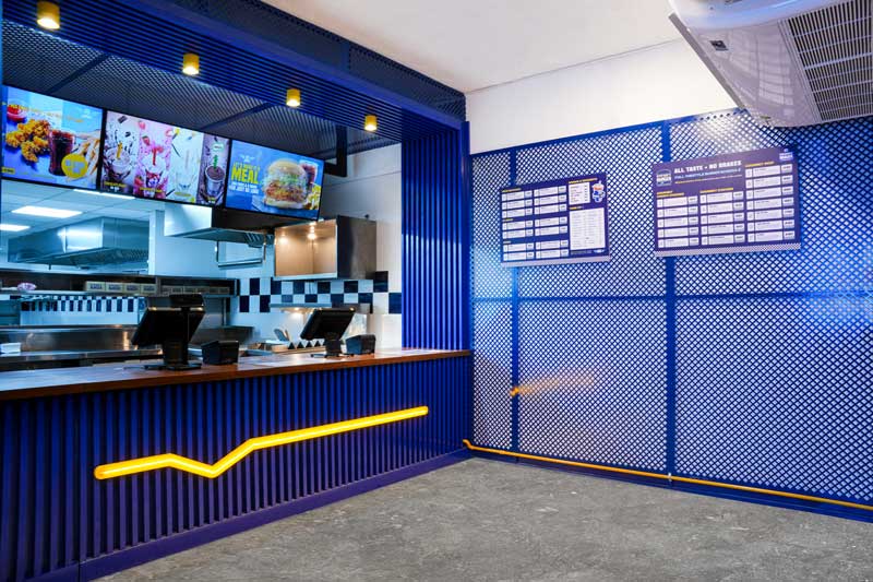 Cashier area of Street Burger's Nawala store, showcasing the menu board and the modern, inviting interior design.